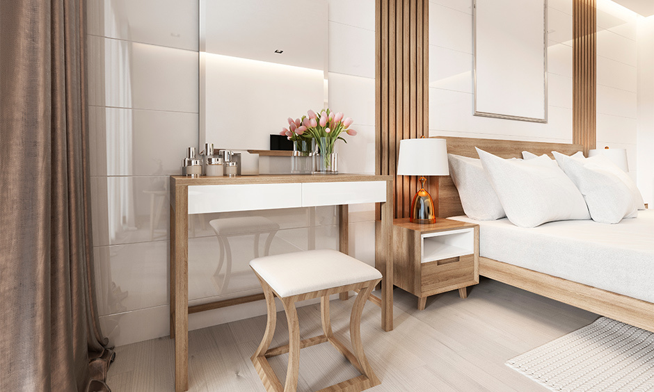 White wooden dressing table with stool in modern bedroom, offering comfort and design