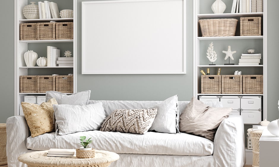 Contemporary coastal interior design with a white sofa, muted pillows, and a woven coffee table