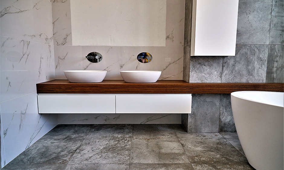 Stylish grey bathroom tile idea enhancing rustic charm in mirror, shower, and feature areas.