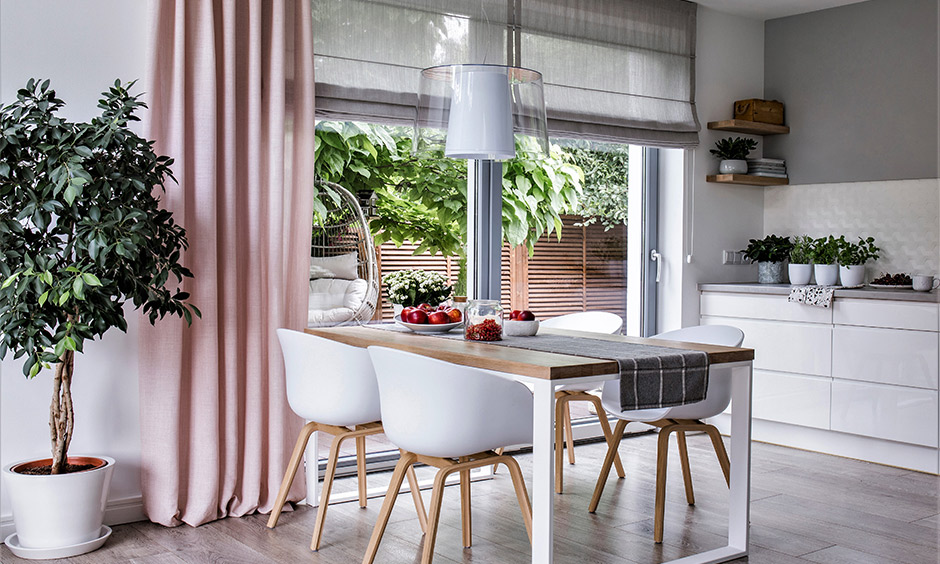 Elegant kitchen glass door design with natural light and greenery view, enhancing airy interiors.