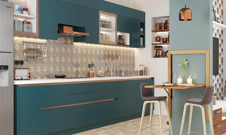 Open-plan kitchen with peacock green cabinets, a white countertop, and a vibrant printed backsplash.