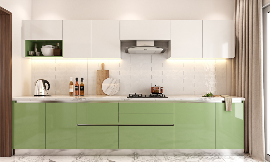 Bright kitchen with sea green cabinets, white marble countertop, and tiled splashback for a fresh, coastal vibe.