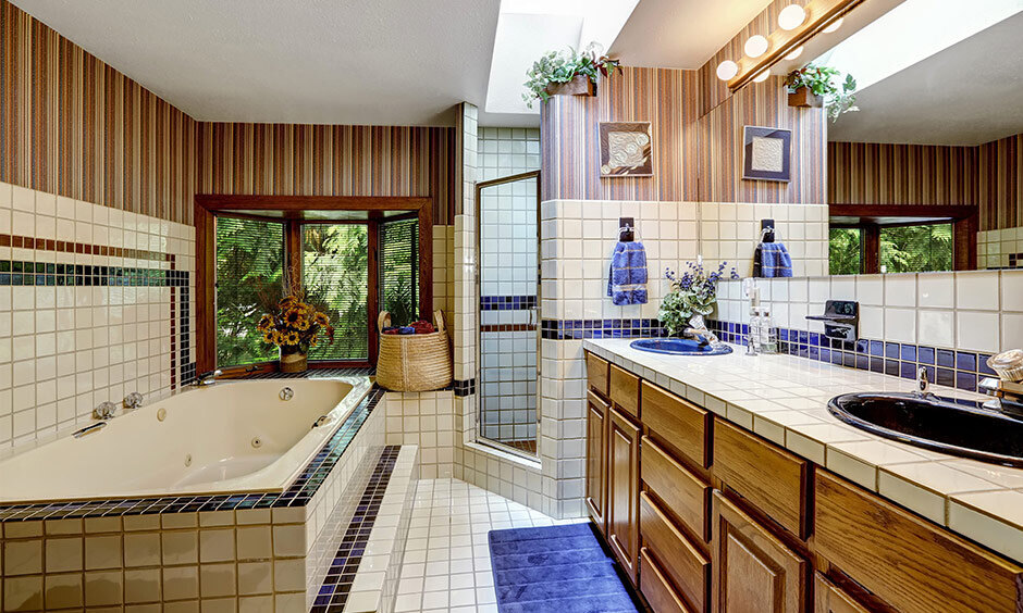 Bathroom tile trends include pairing tiles with waterproof wallpaper for added texture and style.