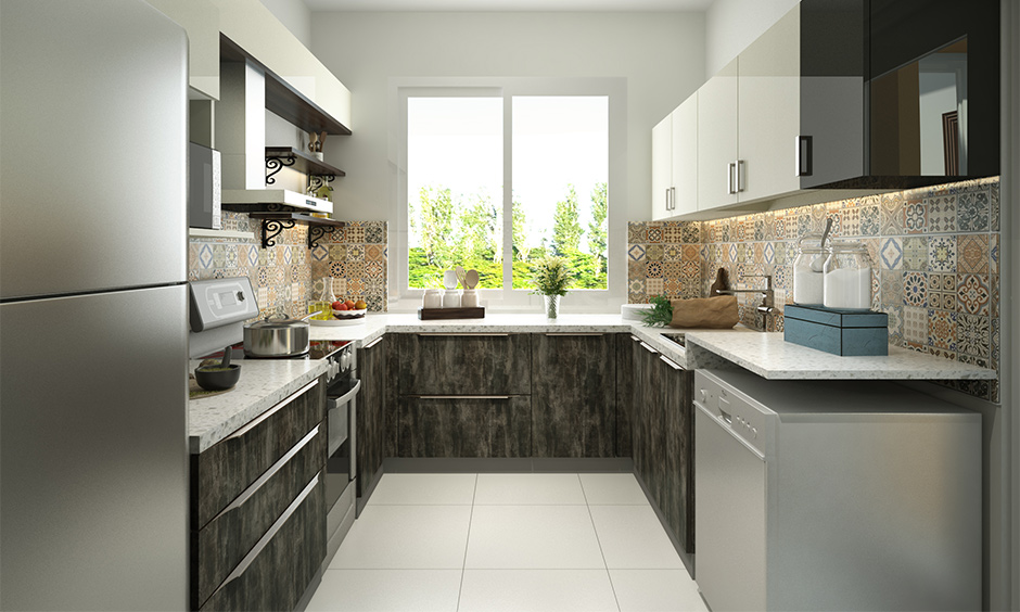 A limited space small U-shaped kitchen with elegant white and grey cabinets, reflecting natural light.
