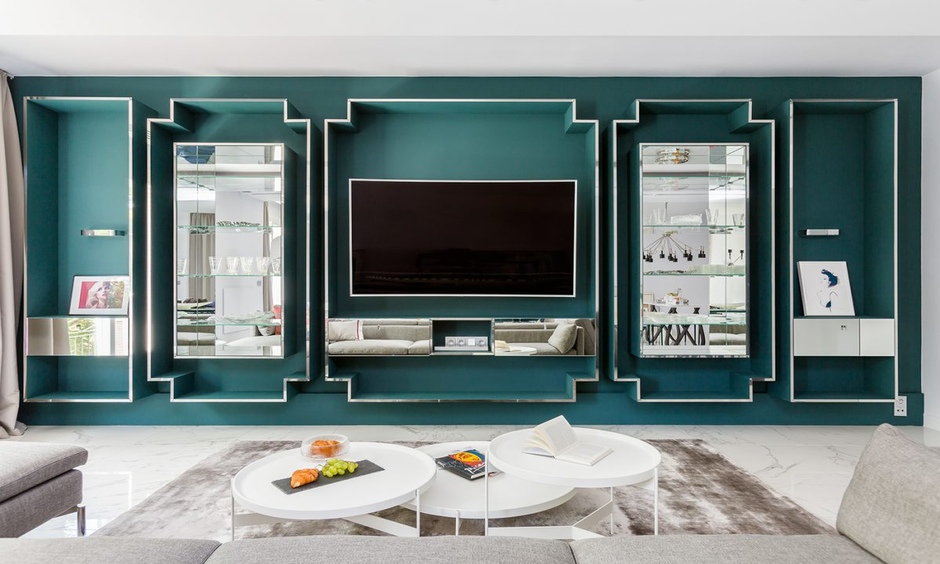 Modern almirah design featuring mirror and glass panels offers display and reflection in a living room.