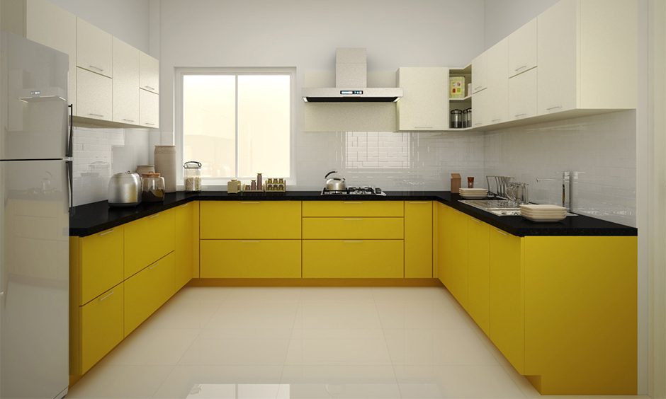 An open-concept small U-shaped kitchen with yellow and off-white cabinets for a bright, spacious feel.