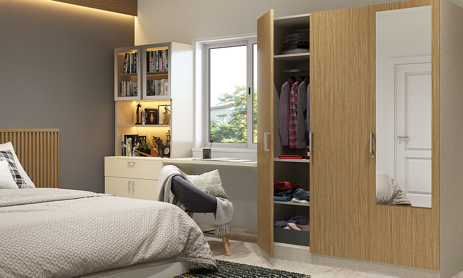 3-door wooden wardrobe design offers ample storage without feeling bulky, featuring an attached study unit.