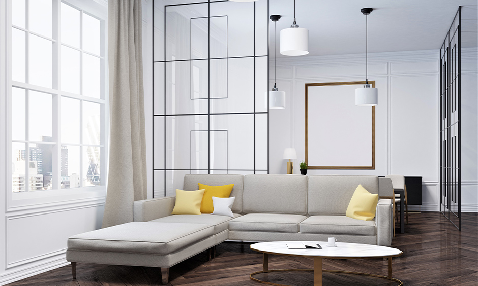3D effect opaque glass partition separating the living and dining rooms with colorful cushions and pendant lights.
