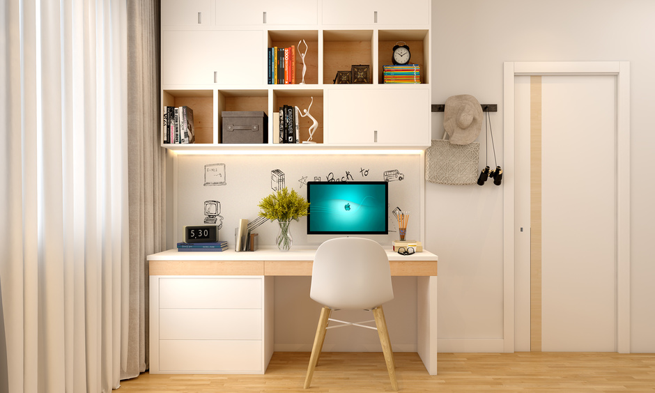 Functional home office setup featuring a space-saving desk, ergonomic chair, and floating shelves for organised storage.