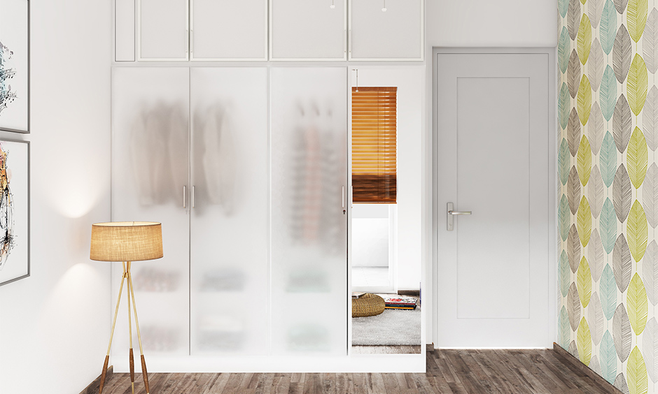 Frosted glass design for the wardrobe door offers stylish privacy while enhancing compact room aesthetics.