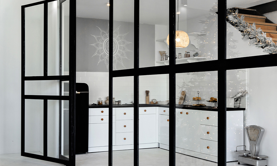 Hinged-door kitchen glass design inspired by French windows brightens and expands the space.