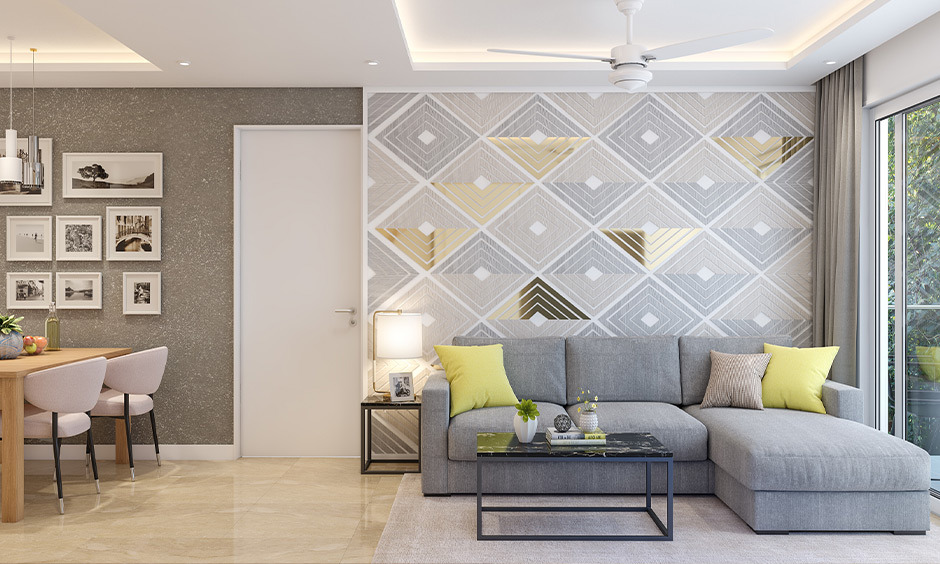 Mirrored 3D wall tiles with geometric patterns in a contemporary living room.