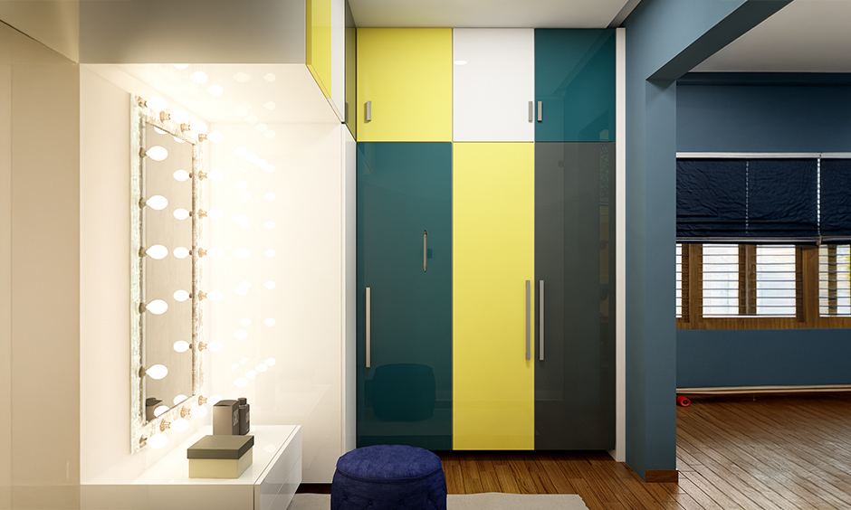 Walk-in wardrobe with peacock blue and lemon yellow combination and vanity mirror