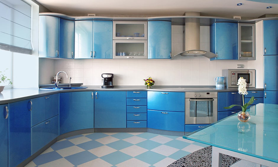 Kitchen with peacock blue and cornflower blue cabinets and green potted plant
