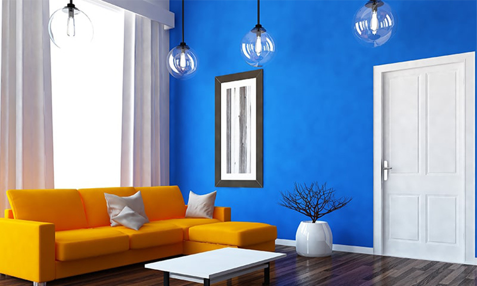 Living room with vibrant peacock blue and citrus orange colour combination