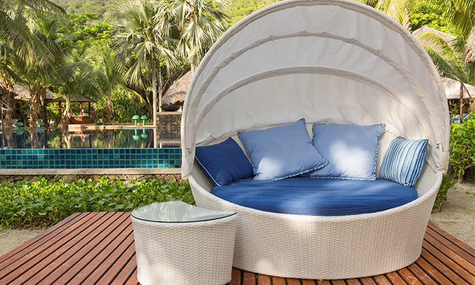 Round canopy lounger with plush cushions, offering a cosy spot to relax by the pool or in the backyard.