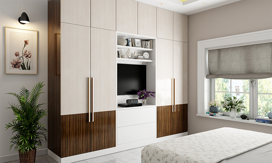 Simple wooden wardrobe design offers 20% extra storage, a TV spot, and a clutter-free bedroom look.