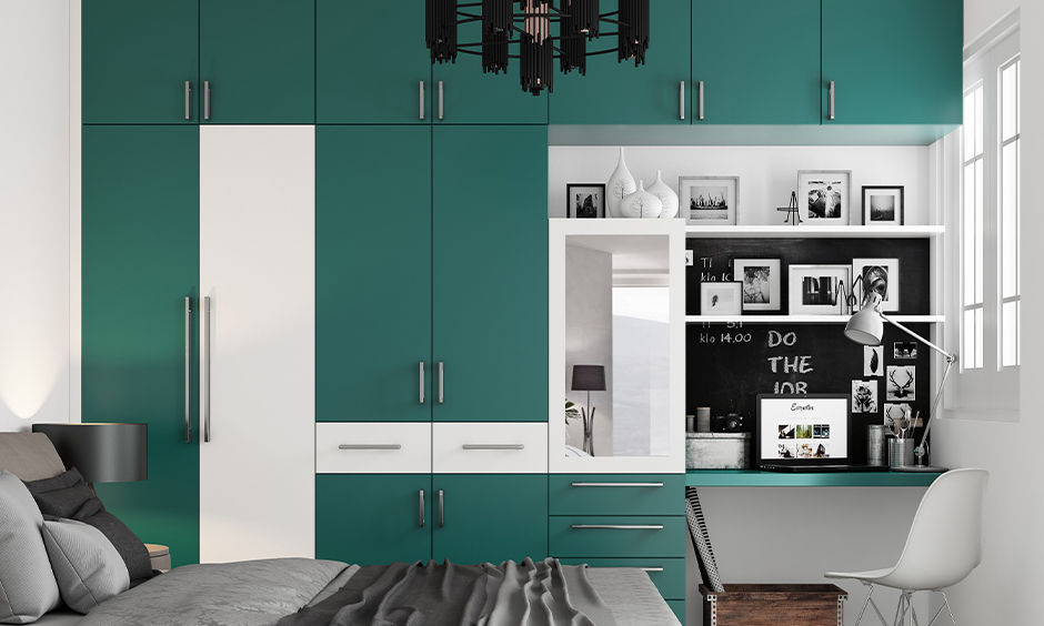 A chic bedroom featuring a dramatic teal and grey palette