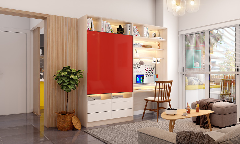 A modern red wall unit with a sliding door, open shelves, and a hidden workstation for a clutter-free living space.