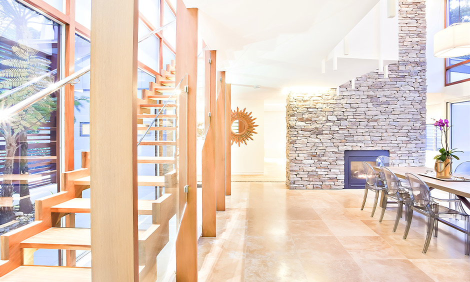 Wood and glass railing design creates a rustic yet open feel, connecting the space with nature.