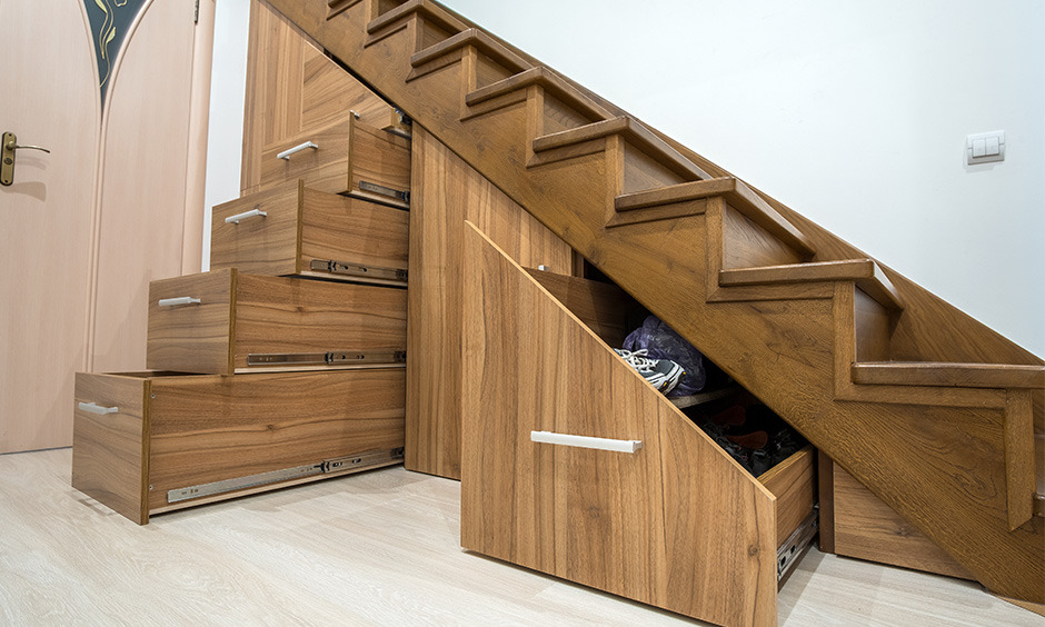 Wooden staircase with hidden storage idea for small space includes drawers for shoes and cleaning supplies.