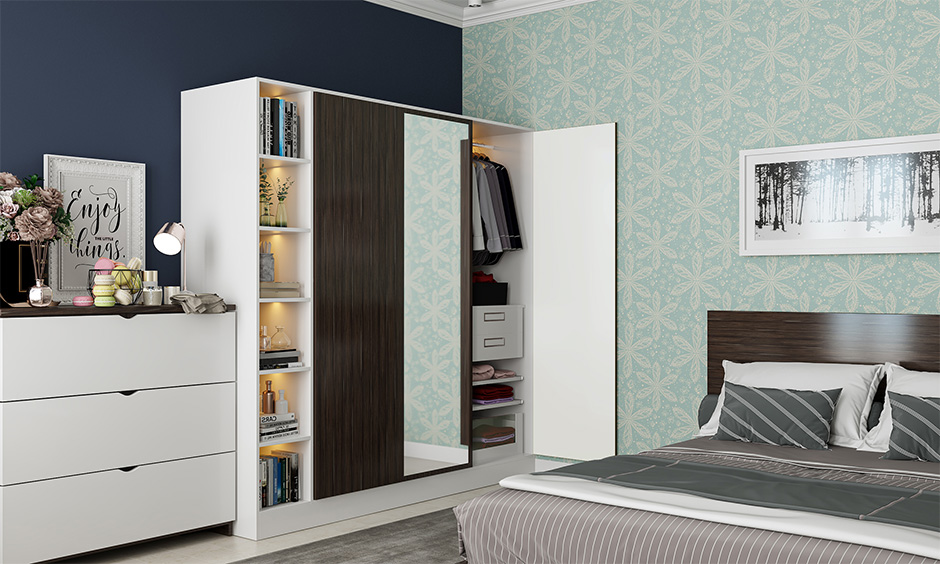 Wooden wardrobe design features a mirror, open shelving for essentials, and soft built-in lighting.