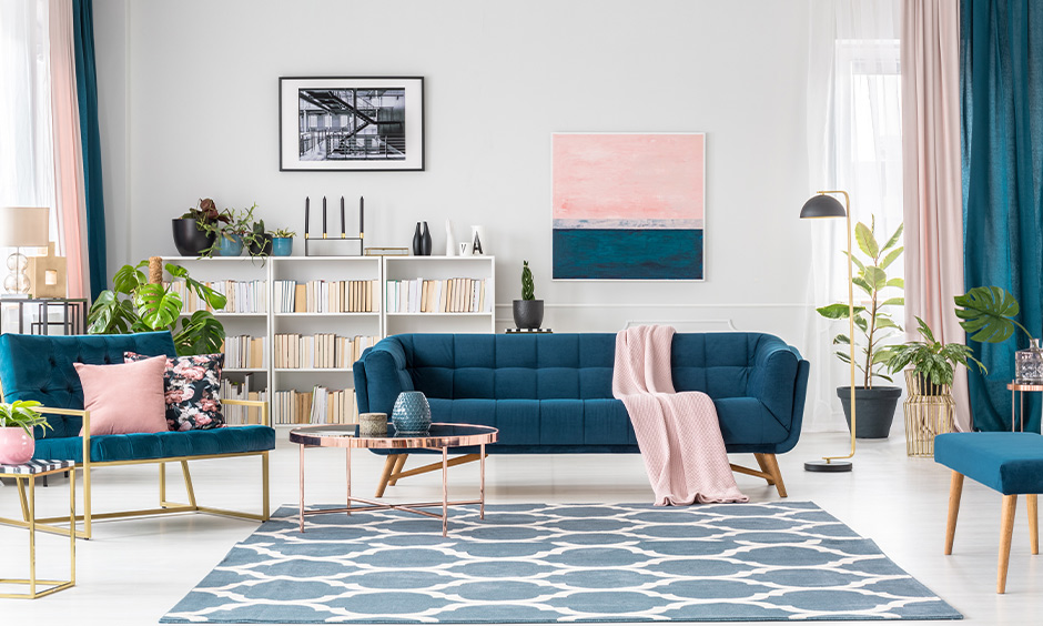 An elegant drawing room interior with a neutral base complemented by jewel tones and metallic finishes.
