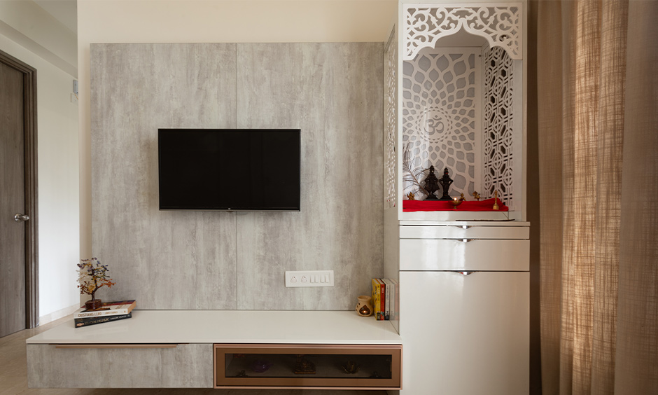Free-standing luxury pooja room with white gloss finish, acrylic jaali, crown, and storage drawers.