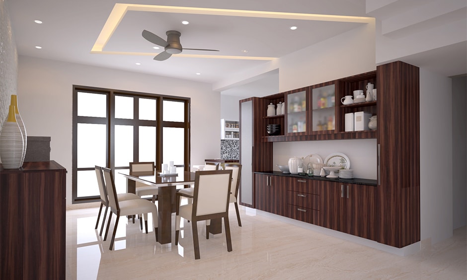 Frosted glass crockery unit elegantly displays dishes while keeping the space light and refined.