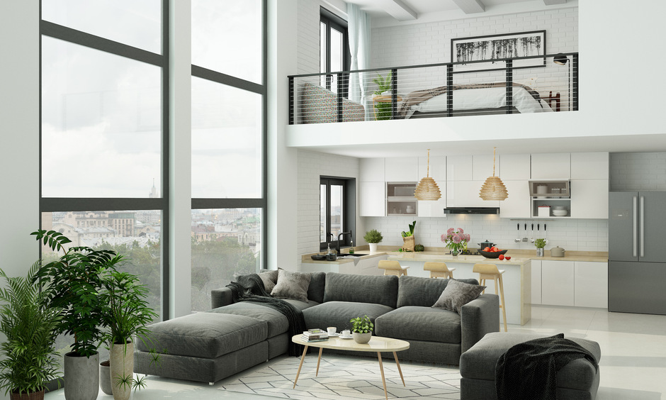 Spacious loft-style apartment with open floor plan, visible kitchen, and modern furnishings.