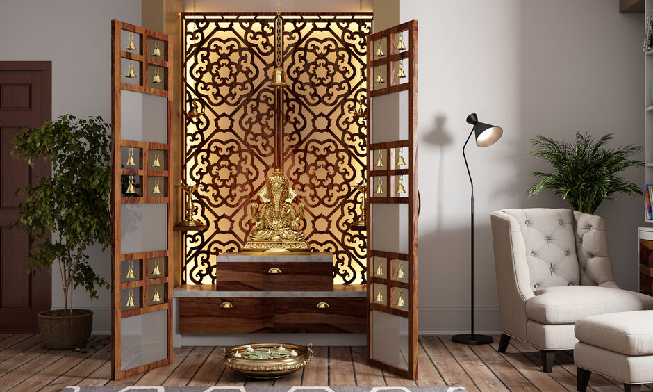 Luxury pooja room with jali partition, soft lighting, temple bells, and organised storage shelves.