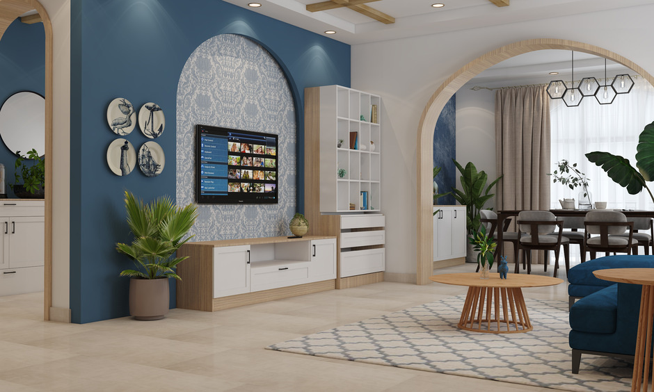 A pop arch design for the TV unit with a deep blue shade and intricate Moroccan-inspired wallpaper.