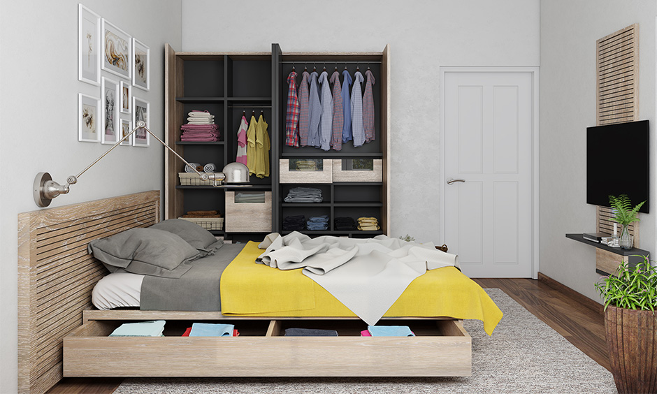 Small modular bedroom with platform bed featuring pull-out storage drawers and sleek wardrobe.