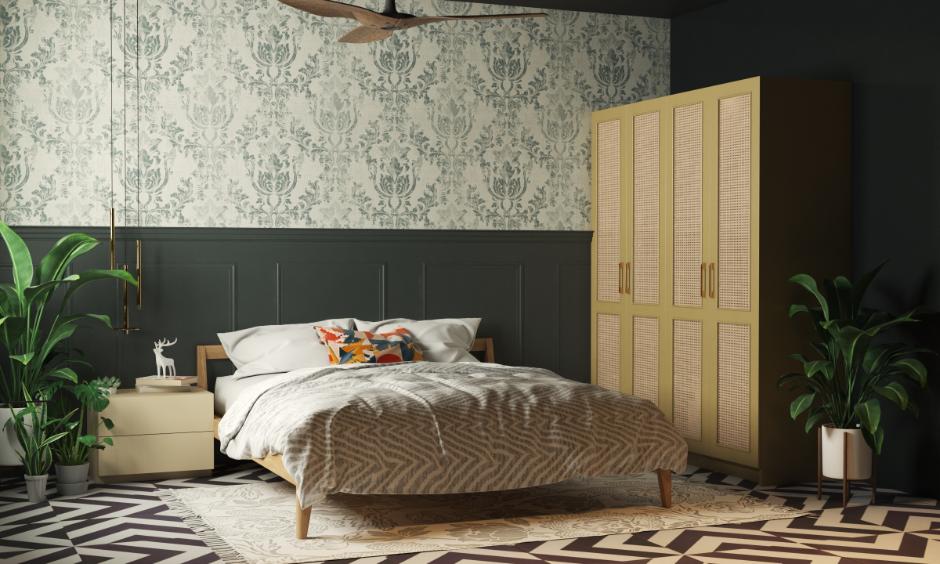 Deep forest green bedroom with white bed linen and rustic decor symbolising grounded, emotional love