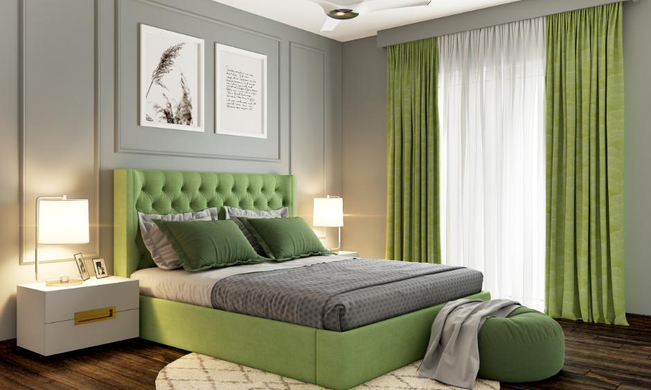 Sage green bedroom design with cosy bedding and light curtains.