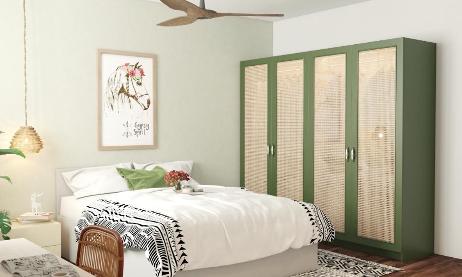 Light green colour bedroom design with cane furniture and boho bedding.