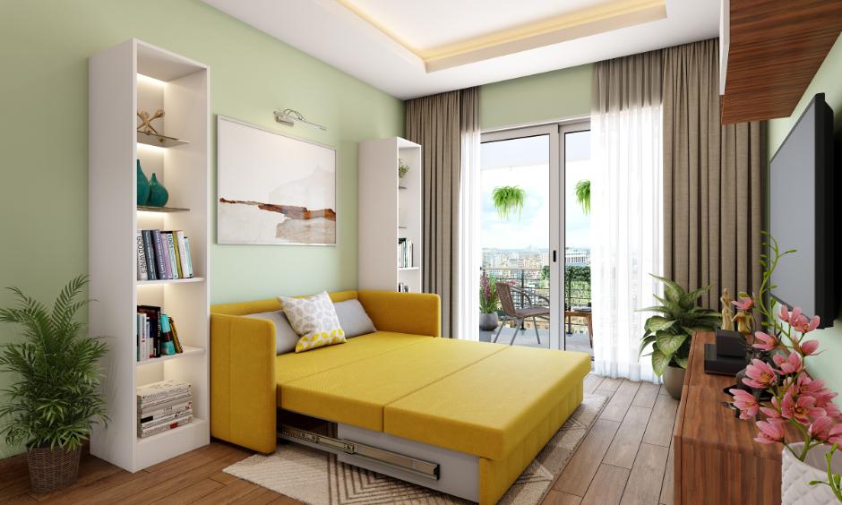 Bedroom with light green walls, vibrant furniture, wooden flooring, and potted plants.