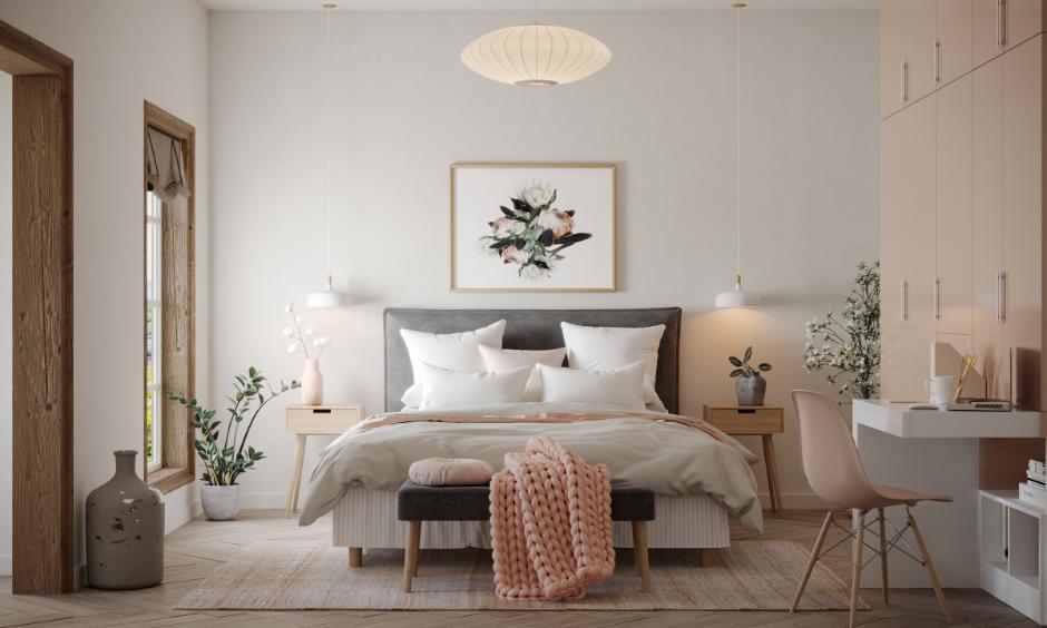 Dusty pink and white bedroom with plush cushions and soft pendant lights for a gentle, romantic vibe