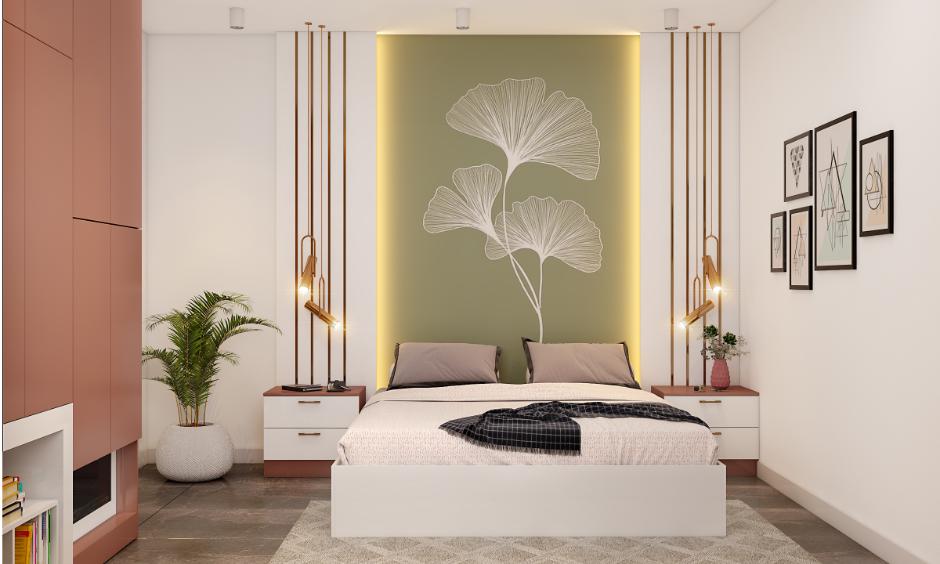 Soft moss green and pink bedroom with clean white walls and quirky frames for a fun, modern couple's room
