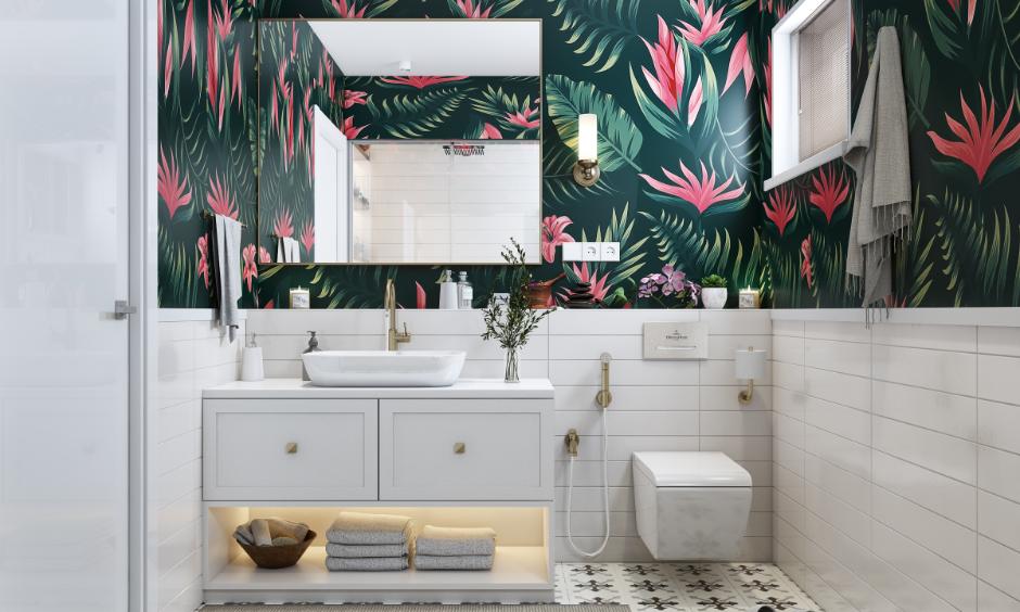 Modern bathroom featuring tropical floral wallpaper, white tiles and gold fixtures.