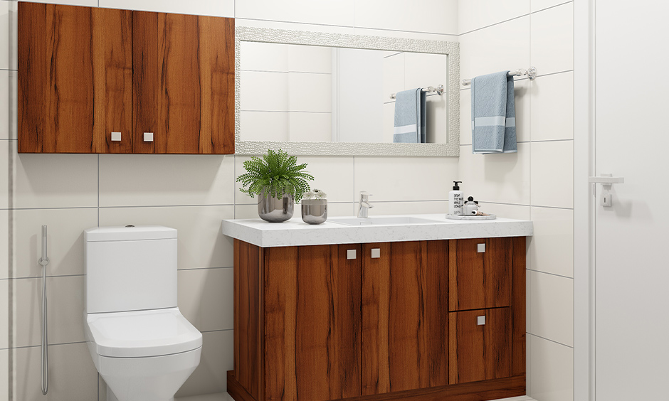 Wall-mounted wood vanity with granite top and plant accents maximises vertical space.
